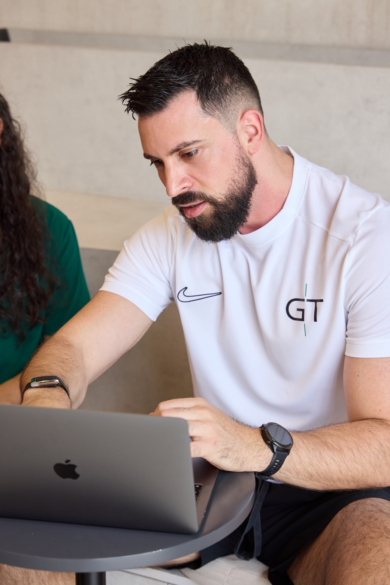 Goran reviewing a training plan on a laptop